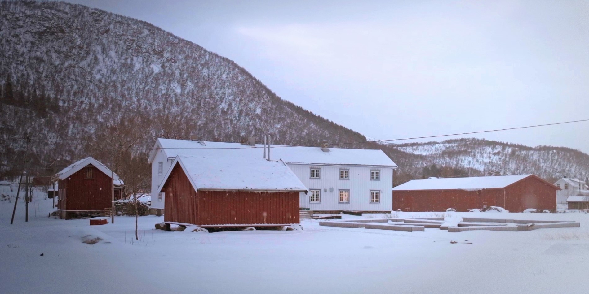 Kvitnes Farm. Red and white farm houses in Winter