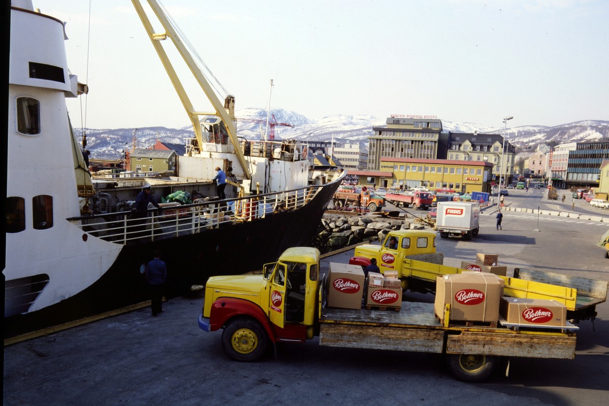 Truck stopping by a large Hurtigruten ship