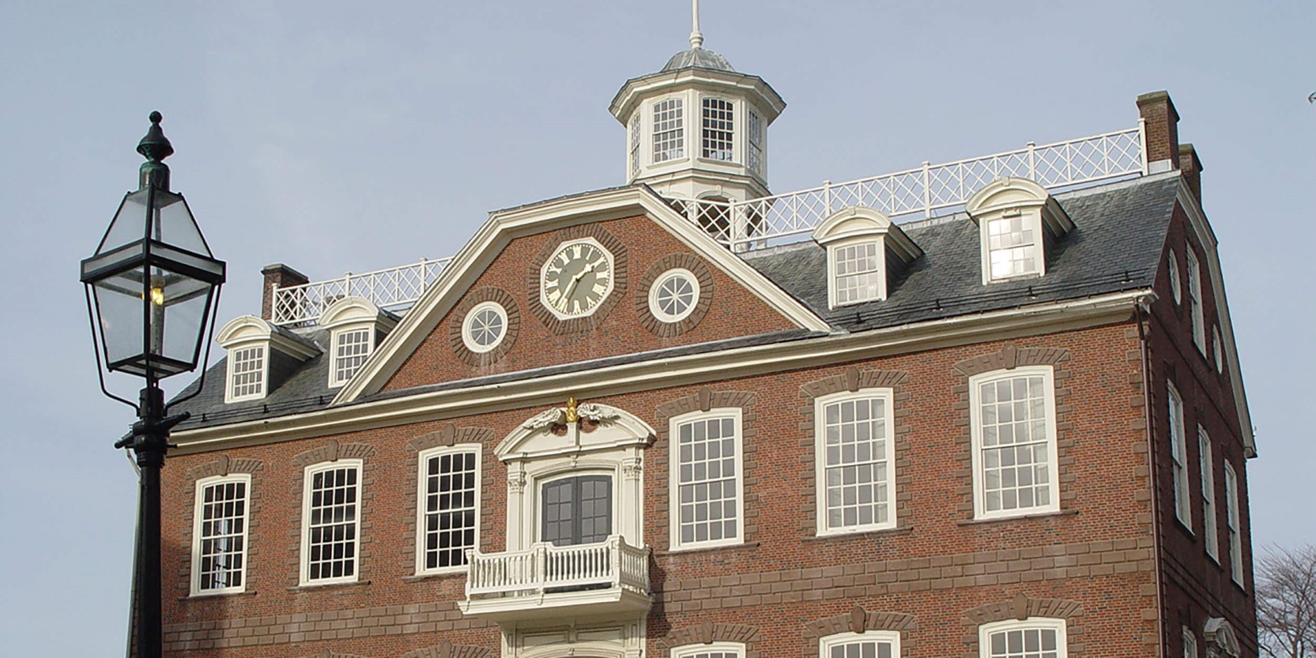 A clock tower in front of a brick building