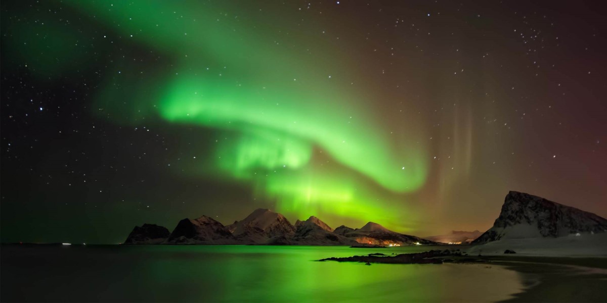 northern lights causes hurtigruten aurora borealis island lofoten snowy behind